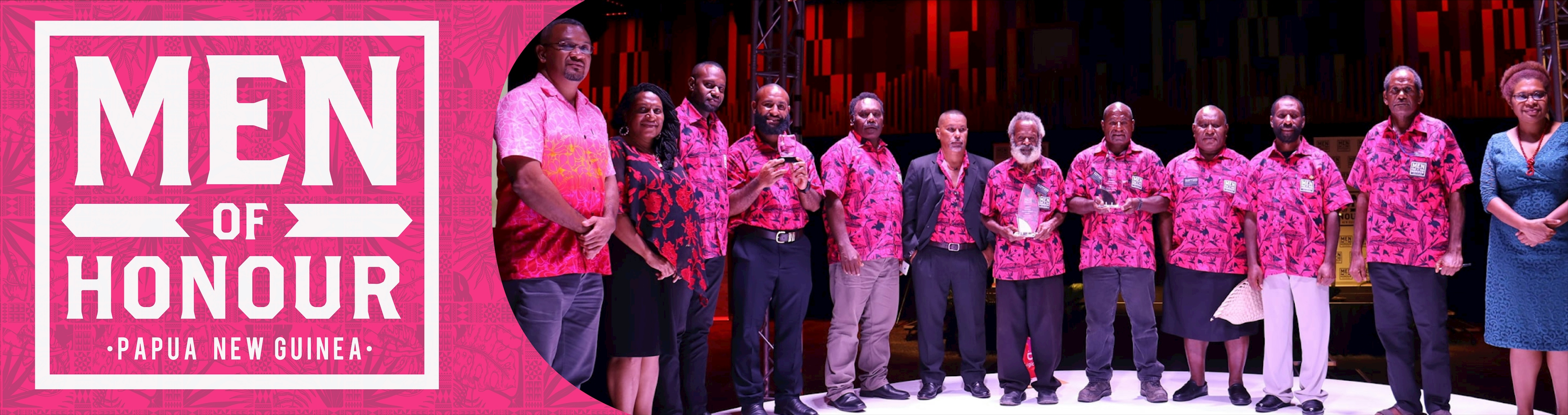 A group of men wearing pink shirts receiving awards